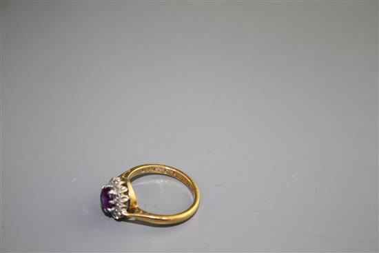 A modern 18ct gold, amethyst and diamond set circular cluster ring, size I, gross weight 3.2 grams.